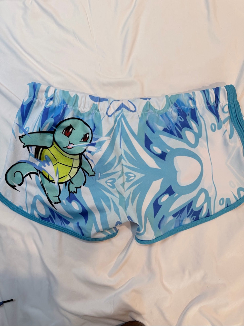 Blue Patterned Swim Shorts with Character Accent